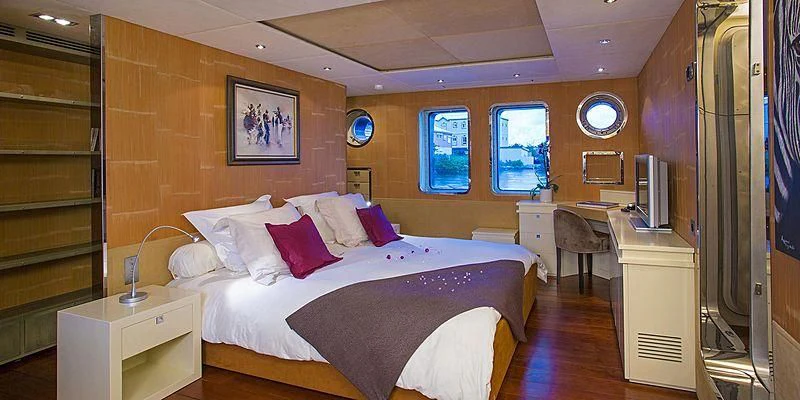 a room with a bed and a desk aboard PAOLYRE Yacht for Sale