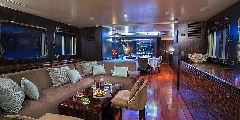 a living room with a couch and a table aboard PAOLYRE Yacht for Sale