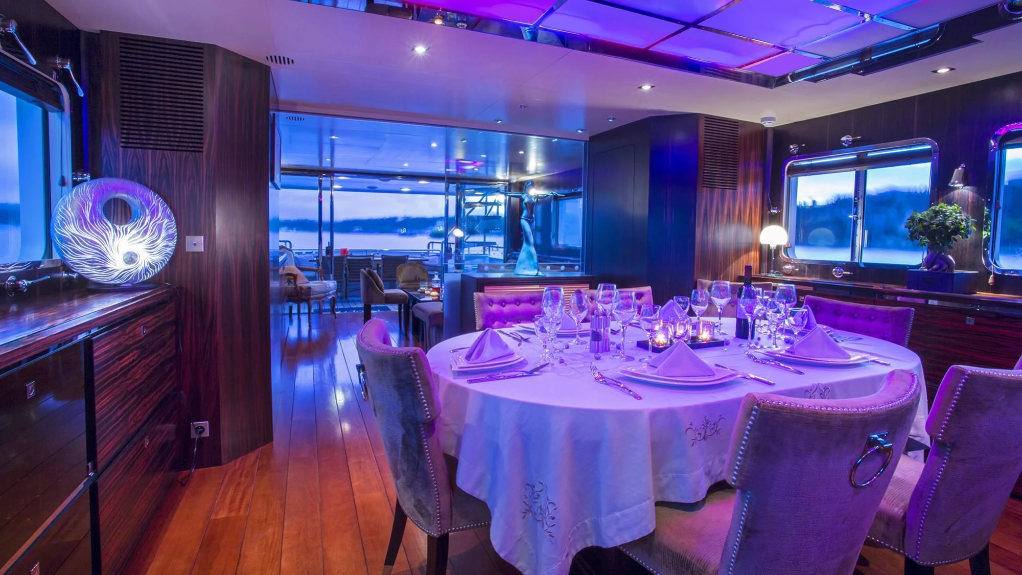 a dining room with a table set aboard PAOLYRE Yacht for Sale