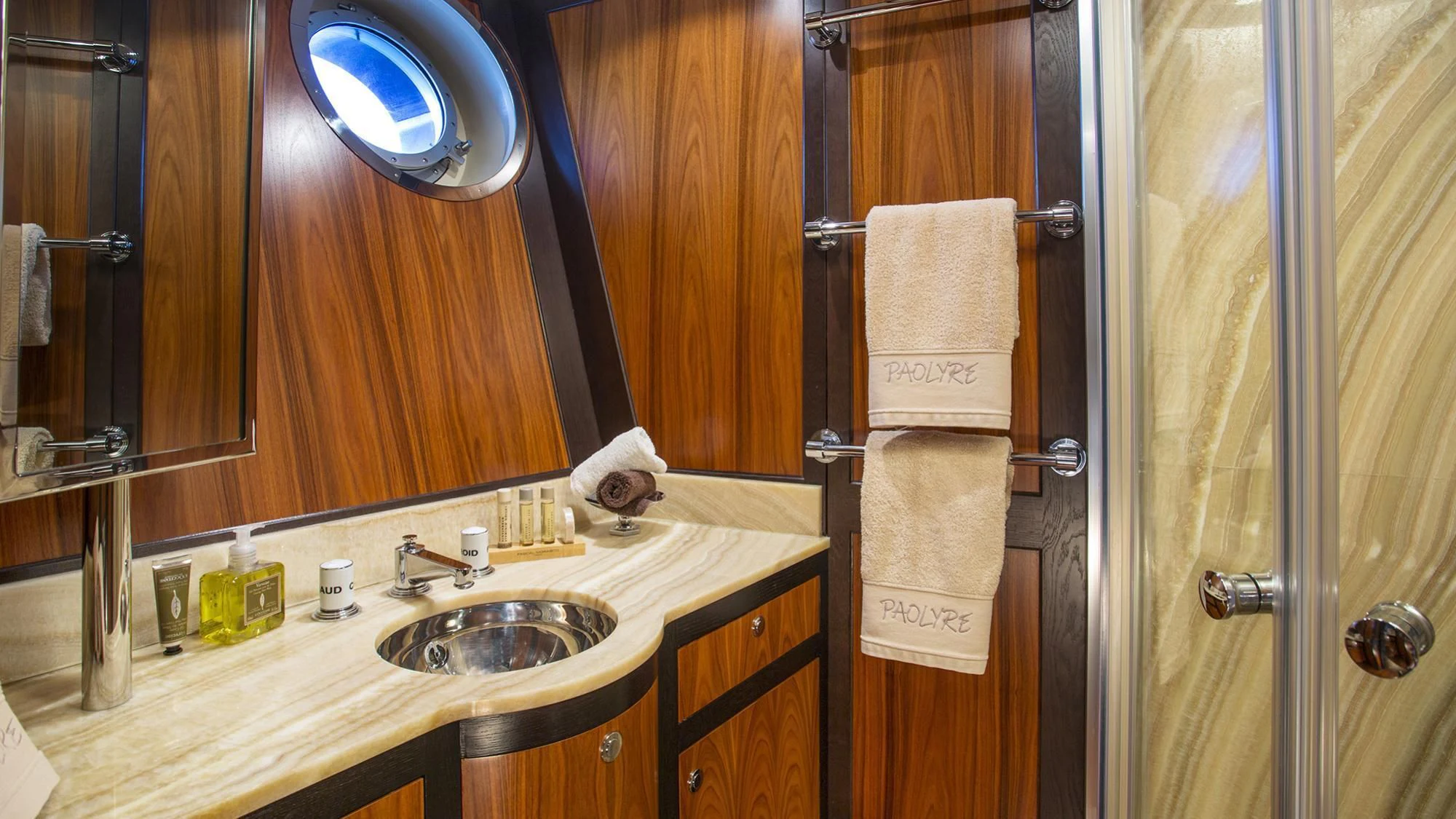 a bathroom with a sink and mirror aboard PAOLYRE Yacht for Sale