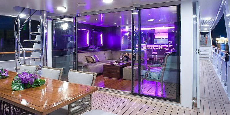 a room with a table and chairs aboard PAOLYRE Yacht for Sale