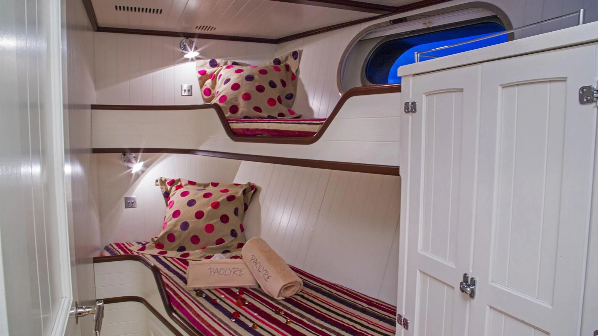 a bed with pillows and a blanket aboard PAOLYRE Yacht for Sale
