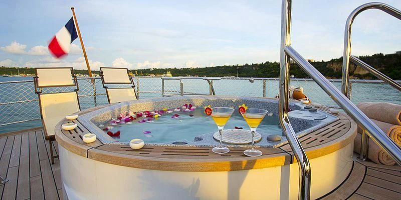 a table with food and drinks on it aboard PAOLYRE Yacht for Sale
