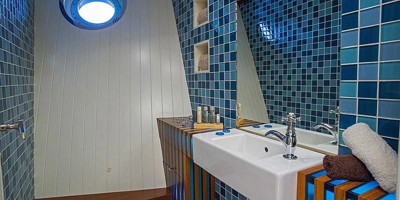 a bathroom with a sink and a mirror aboard PAOLYRE Yacht for Sale