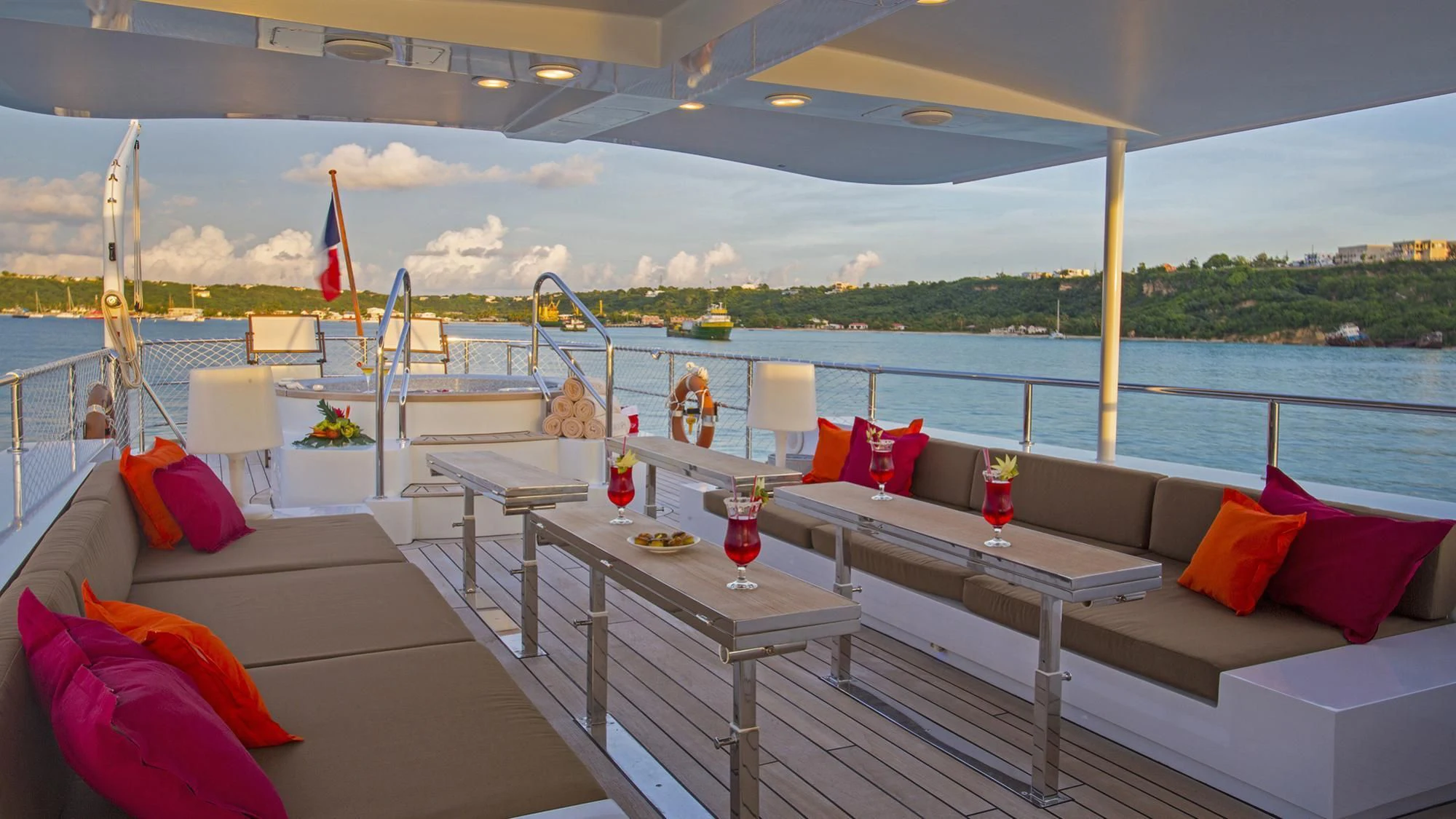 a deck with a table and chairs on it aboard PAOLYRE Yacht for Sale