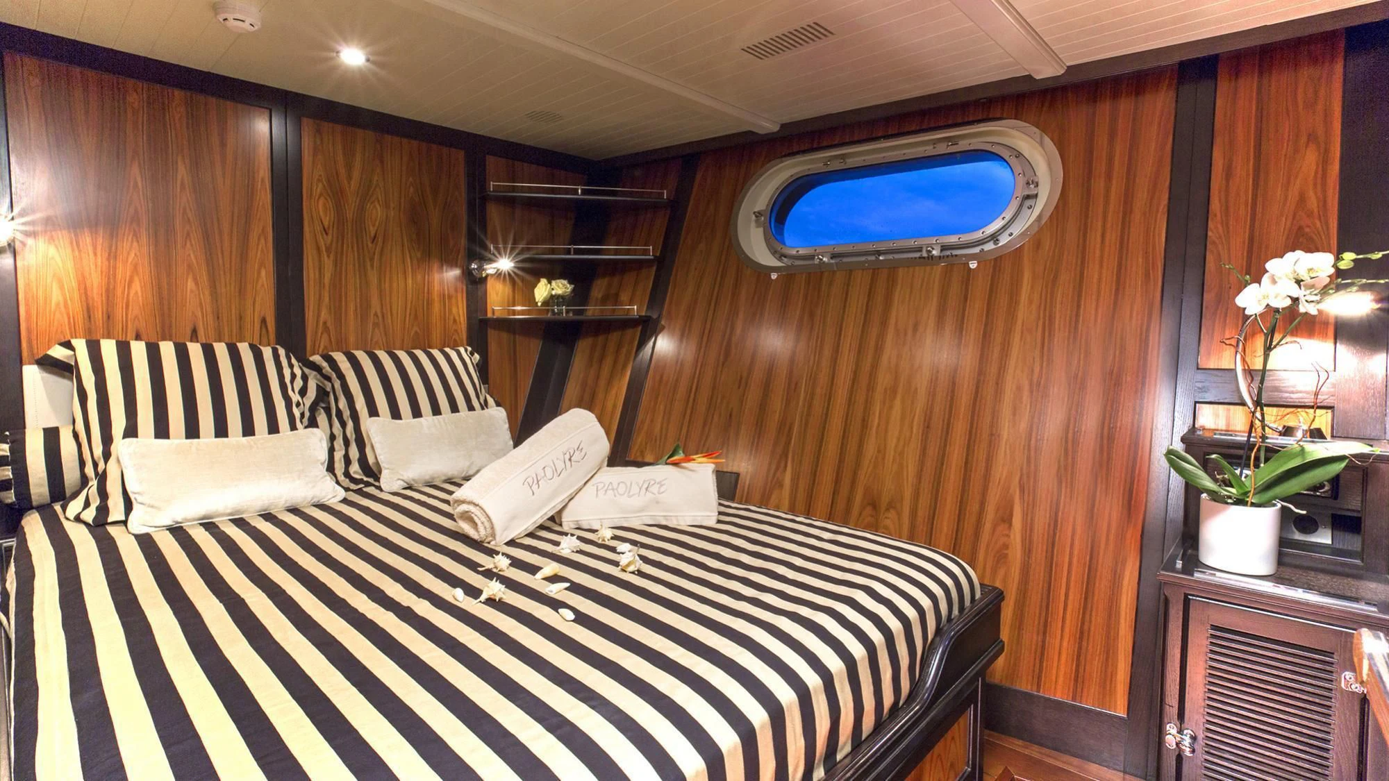 a bed with a black and white checkered sheet and a white pillow aboard PAOLYRE Yacht for Sale