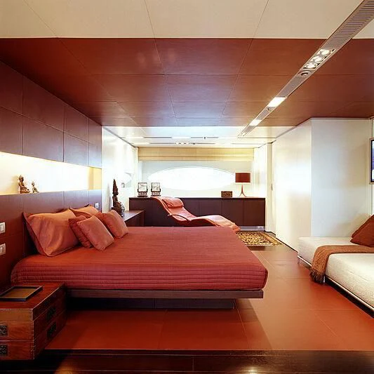 a bedroom with a bed and a couch aboard MY FALCON Yacht for Sale