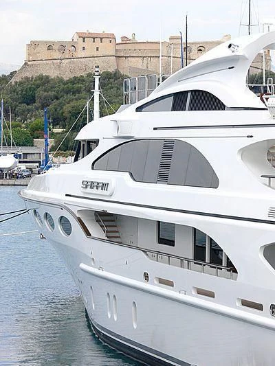 a white boat in a harbor aboard MY FALCON Yacht for Sale