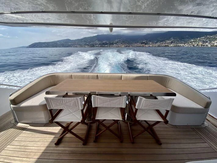 a table and chairs on a deck overlooking a large body of water aboard MELT Yacht for Sale