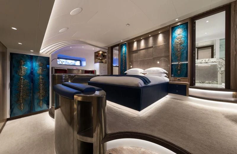 a bedroom with a bed and a desk aboard NGONI Yacht for Sale