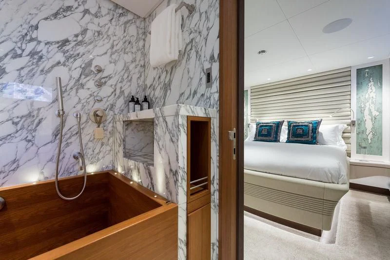 a room with a bed and a desk aboard NGONI Yacht for Sale