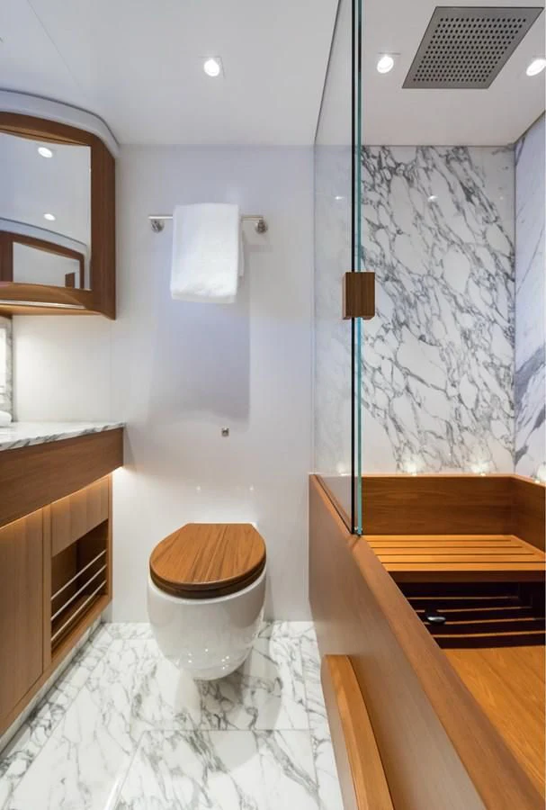 a bathroom with a toilet and a shower curtain aboard NGONI Yacht for Sale