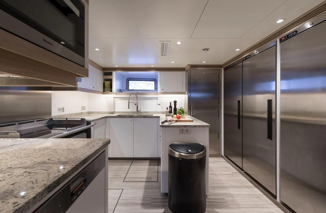 a kitchen with a stainless steel refrigerator aboard NGONI Yacht for Sale