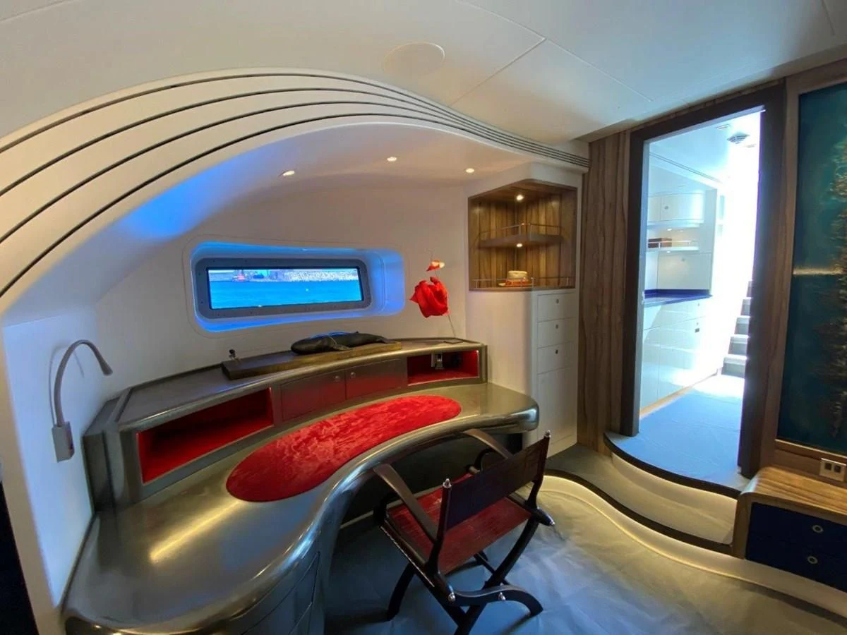 a room with a bed and a desk aboard NGONI Yacht for Sale