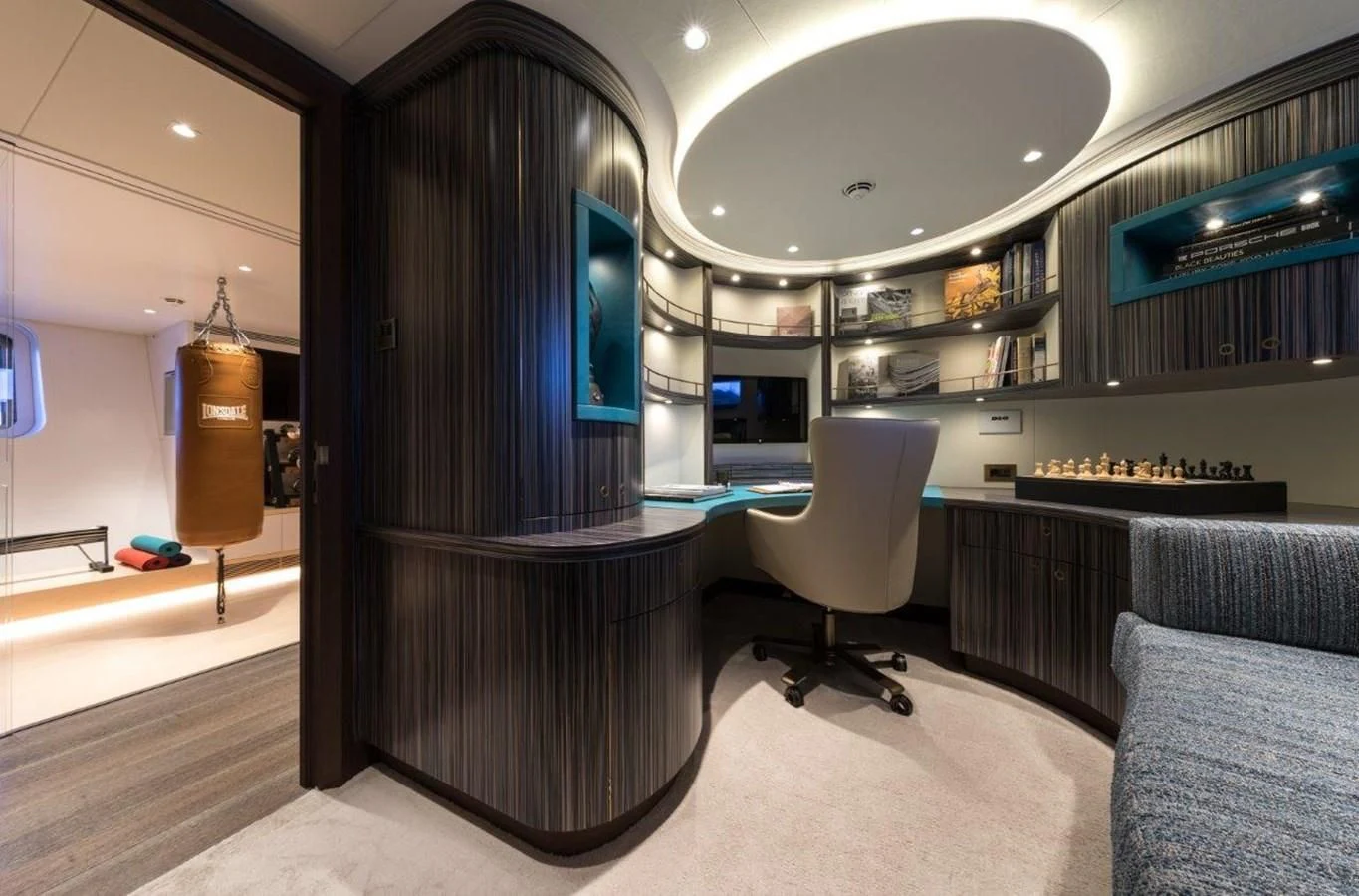 a room with a black wall and a black table and chairs aboard NGONI Yacht for Sale