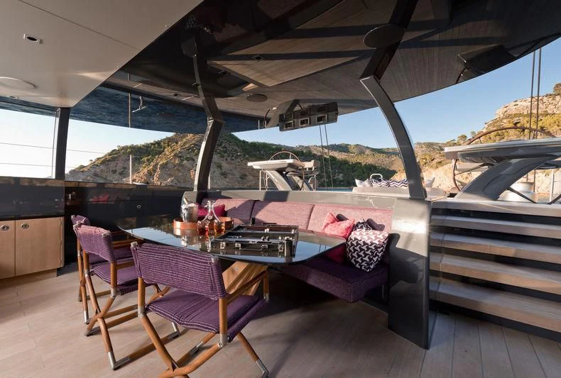 a table and chairs on a deck aboard NGONI Yacht for Sale