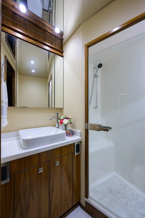 a bathroom with a sink and a mirror aboard SWEETUMS Yacht for Sale