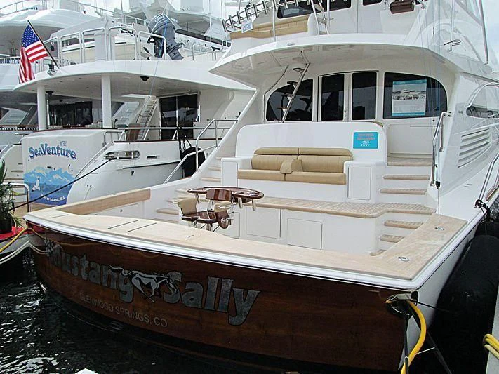 a boat with a flag on the side aboard SWEETUMS Yacht for Sale