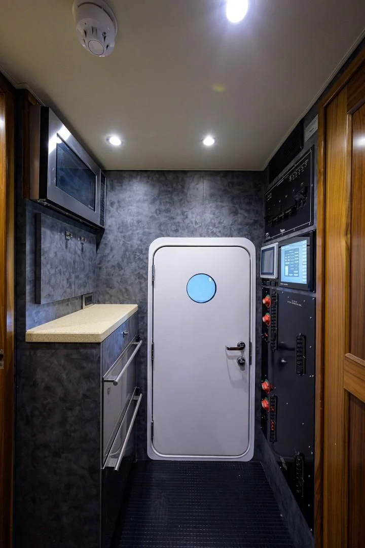 a room with a machine and a door aboard SWEETUMS Yacht for Sale