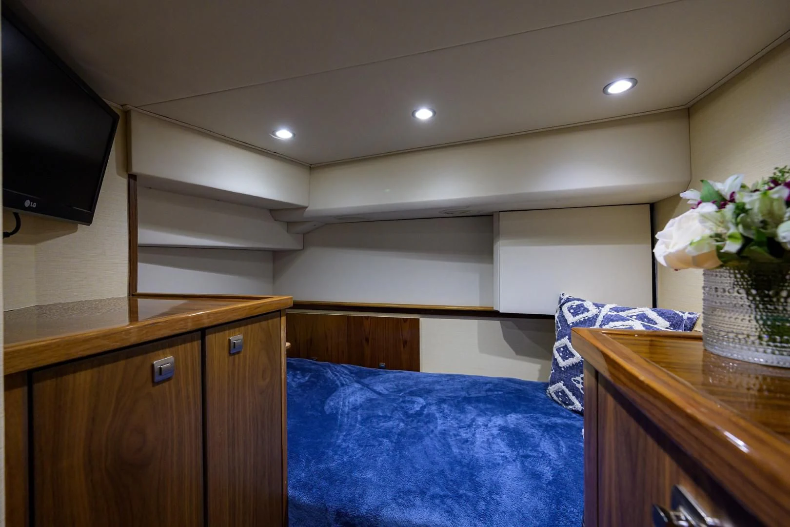 a bedroom with a bed and a television aboard SWEETUMS Yacht for Sale