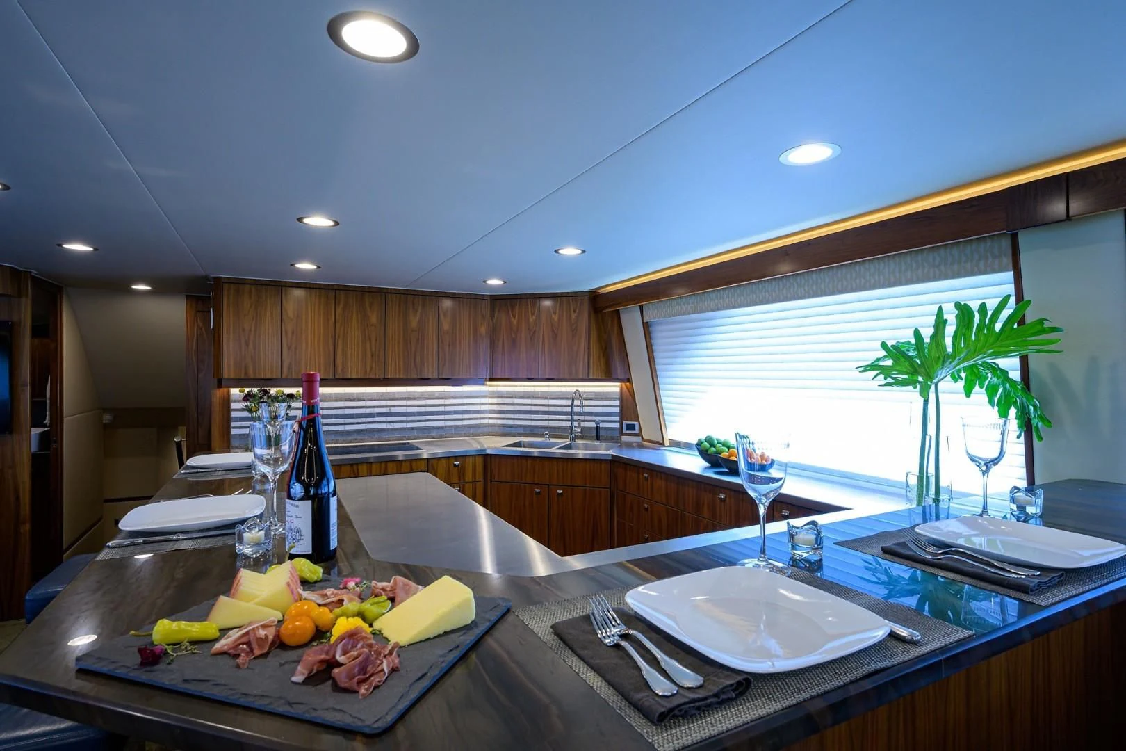a kitchen with a table set with food and drinks aboard SWEETUMS Yacht for Sale