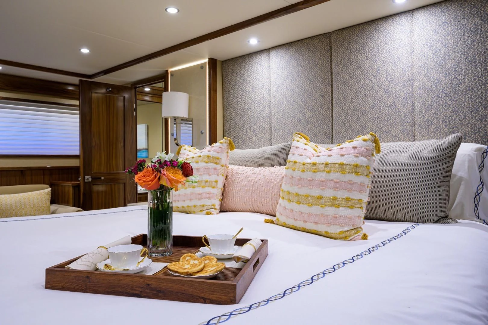 a table with a vase of flowers and a plate of food aboard SWEETUMS Yacht for Sale