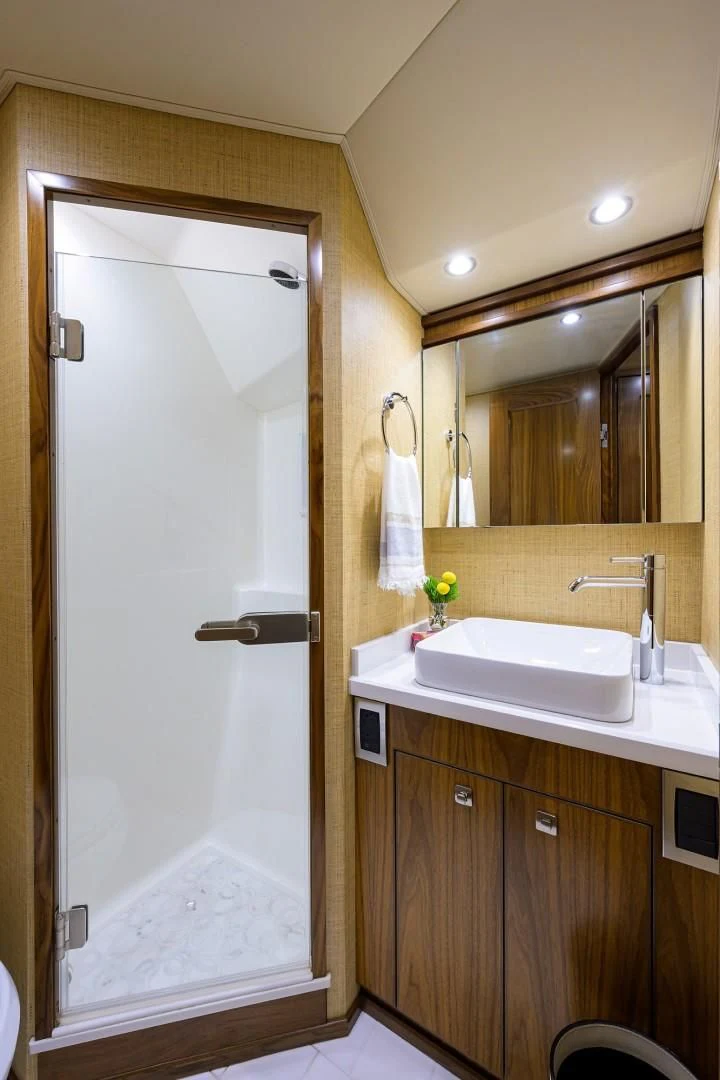 a bathroom with a large mirror aboard SWEETUMS Yacht for Sale