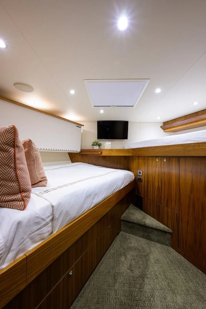 a room with a bed and a television aboard SWEETUMS Yacht for Sale