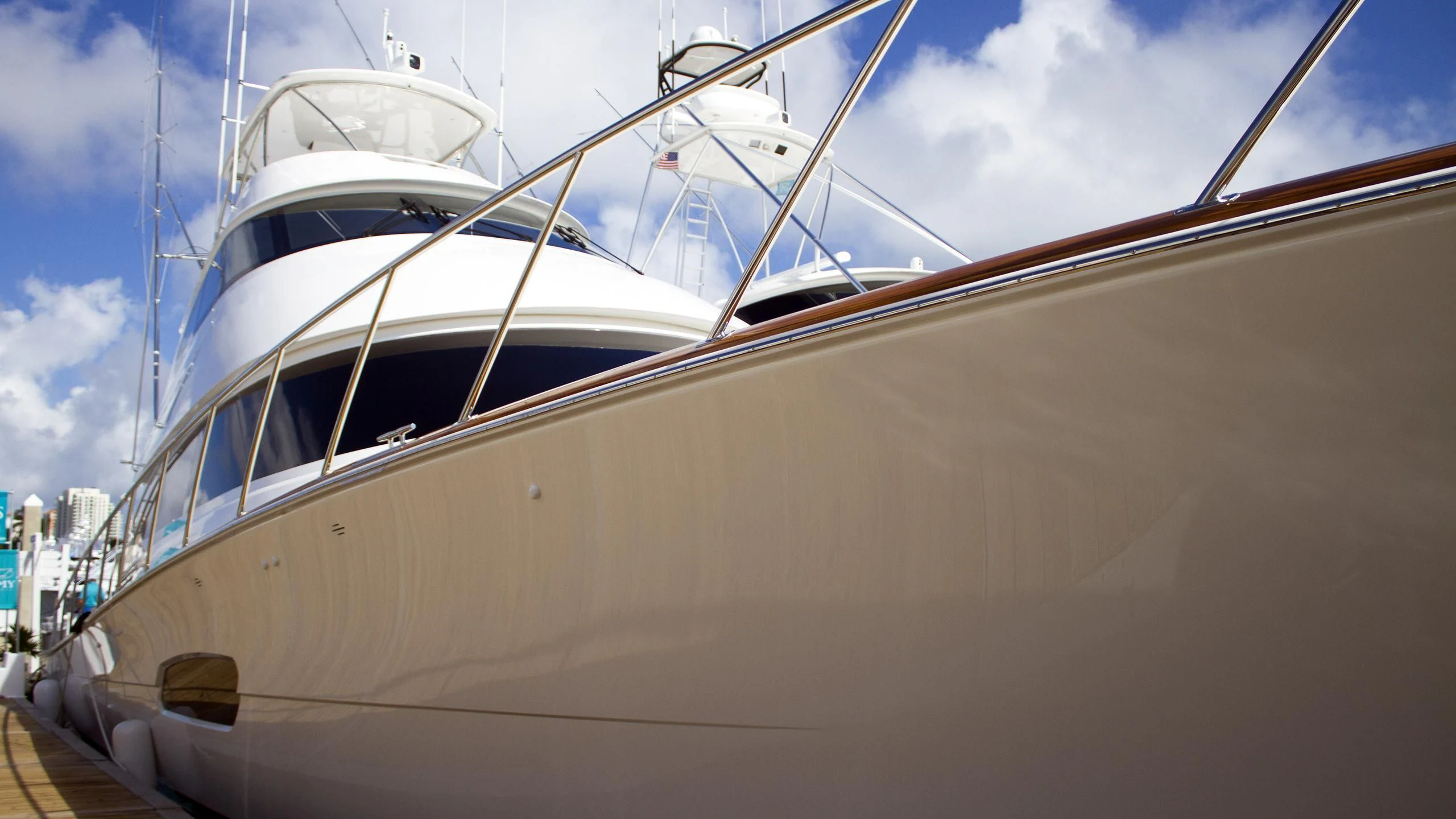 a white boat on a dock aboard SWEETUMS Yacht for Sale