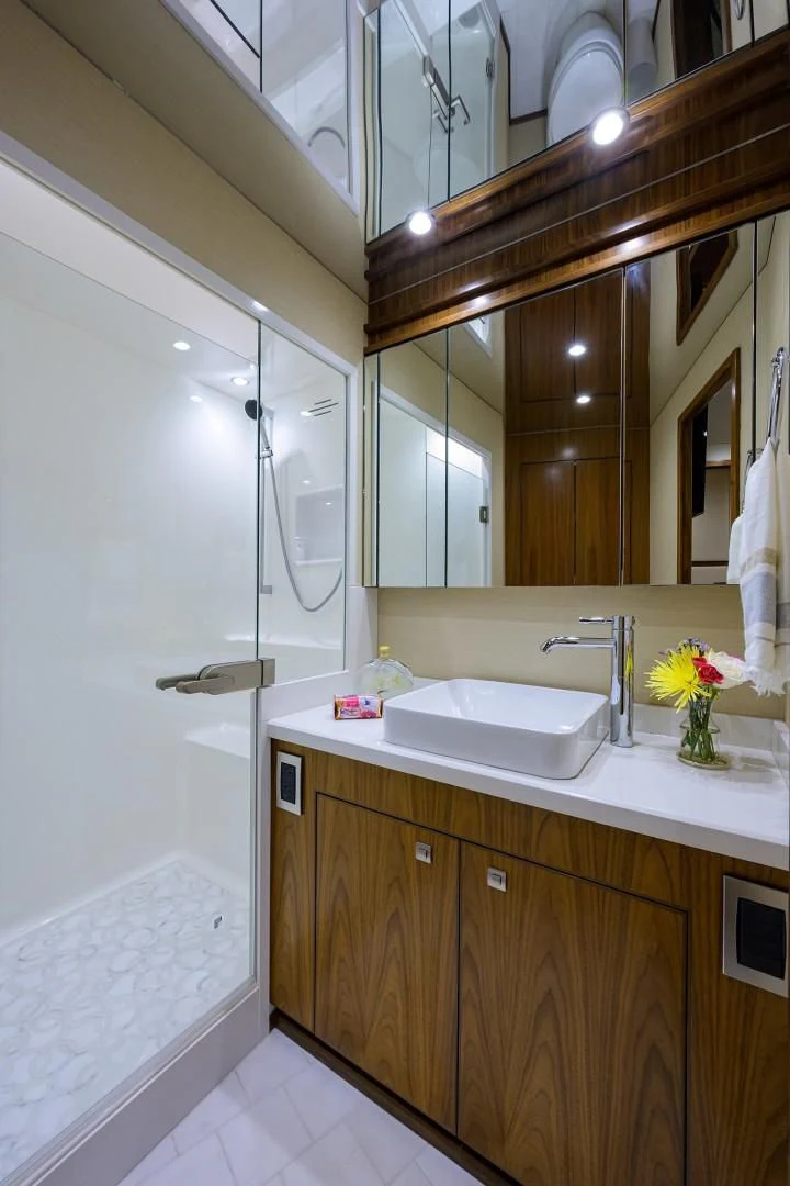 a bathroom with a large mirror aboard SWEETUMS Yacht for Sale