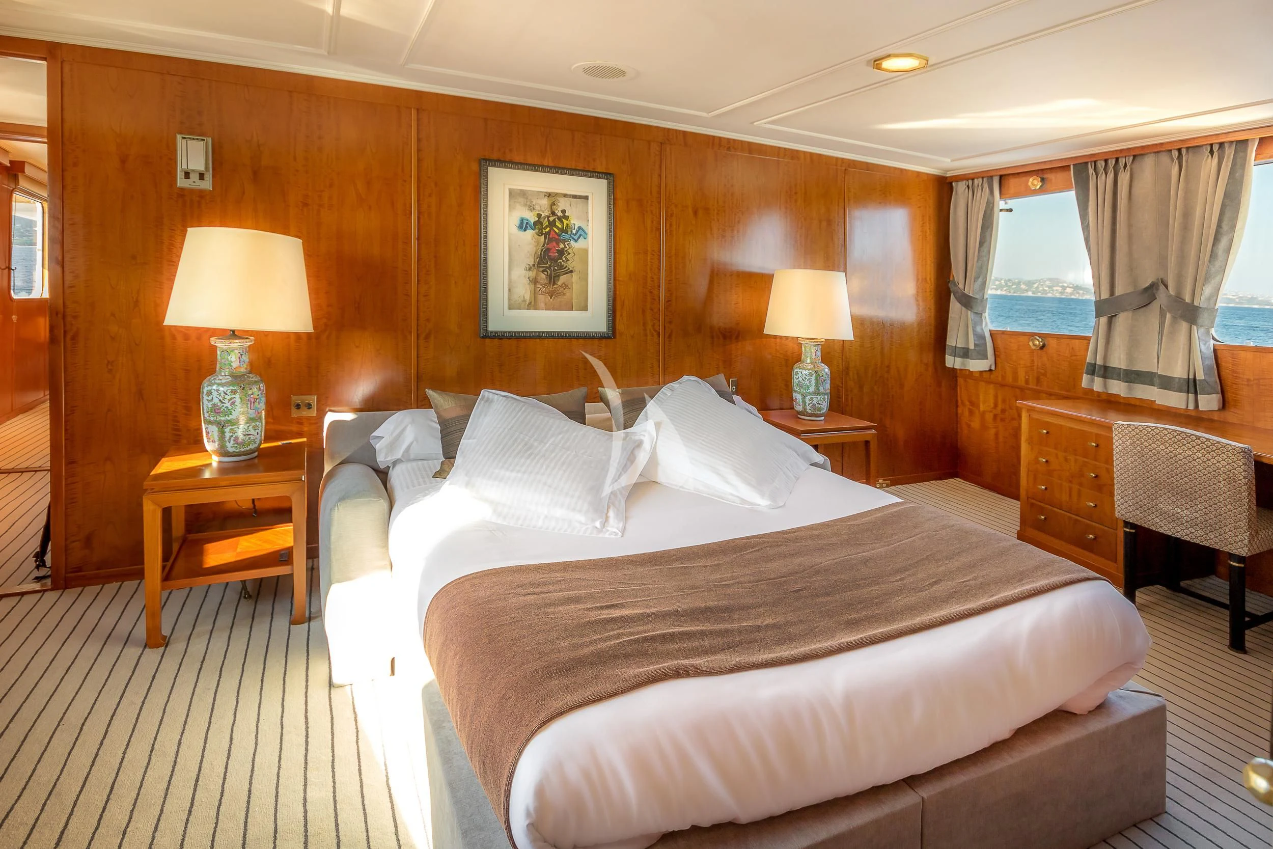 a hotel room with a bed and lamps aboard SECRET LIFE Yacht for Sale