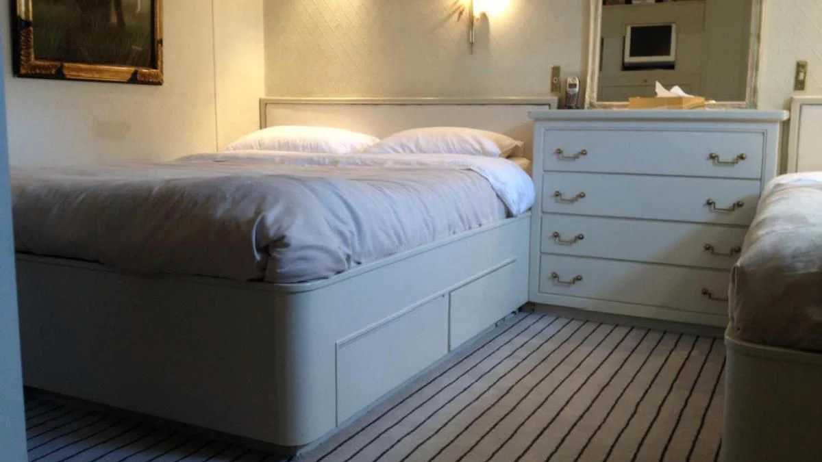 a bed with a blue bed spread aboard SECRET LIFE Yacht for Sale