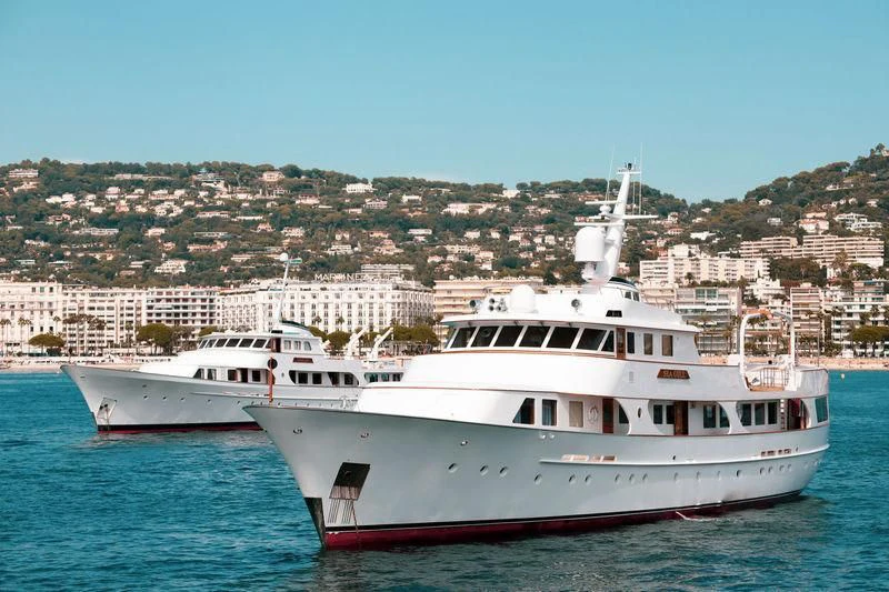 a couple of white boats in the water aboard SECRET LIFE Yacht for Sale
