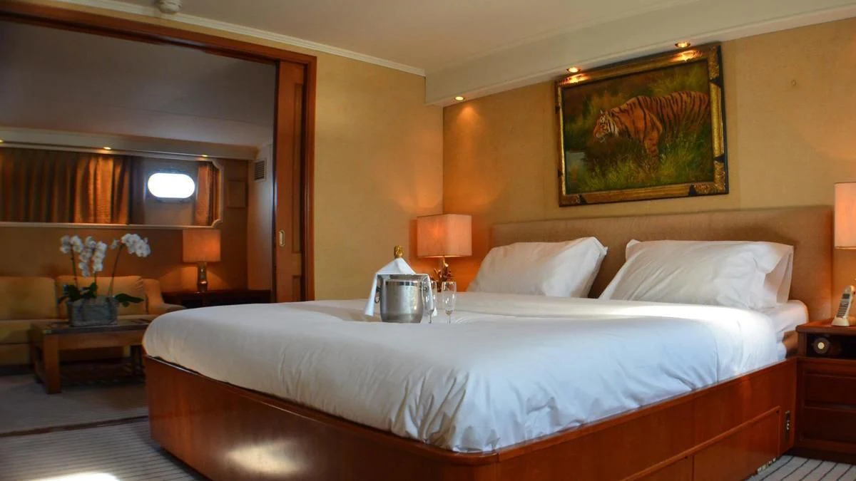 a large bed with white sheets aboard SECRET LIFE Yacht for Sale