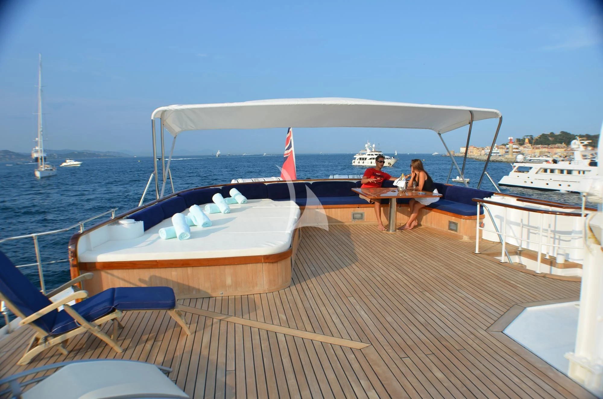 a couple of people sitting on a bench on a dock with boats in the water aboard SECRET LIFE Yacht for Sale