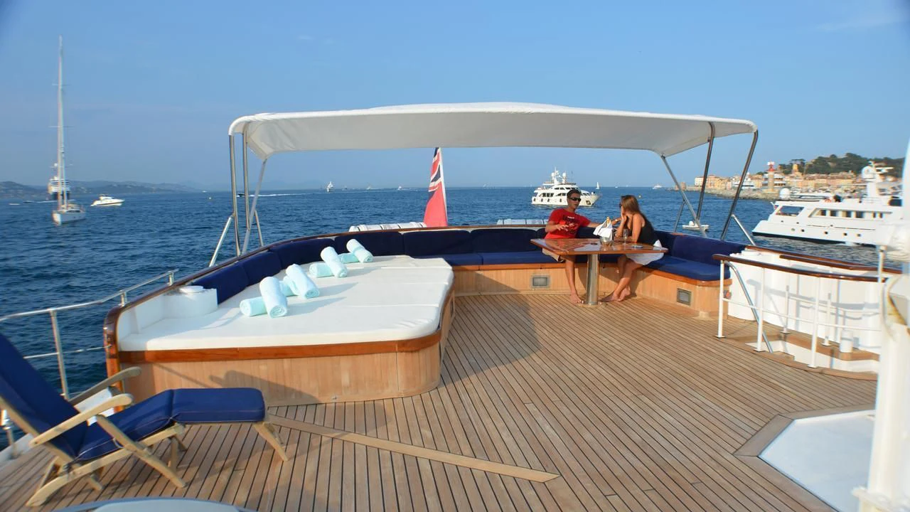 a couple sitting at a table on a boat aboard SECRET LIFE Yacht for Sale