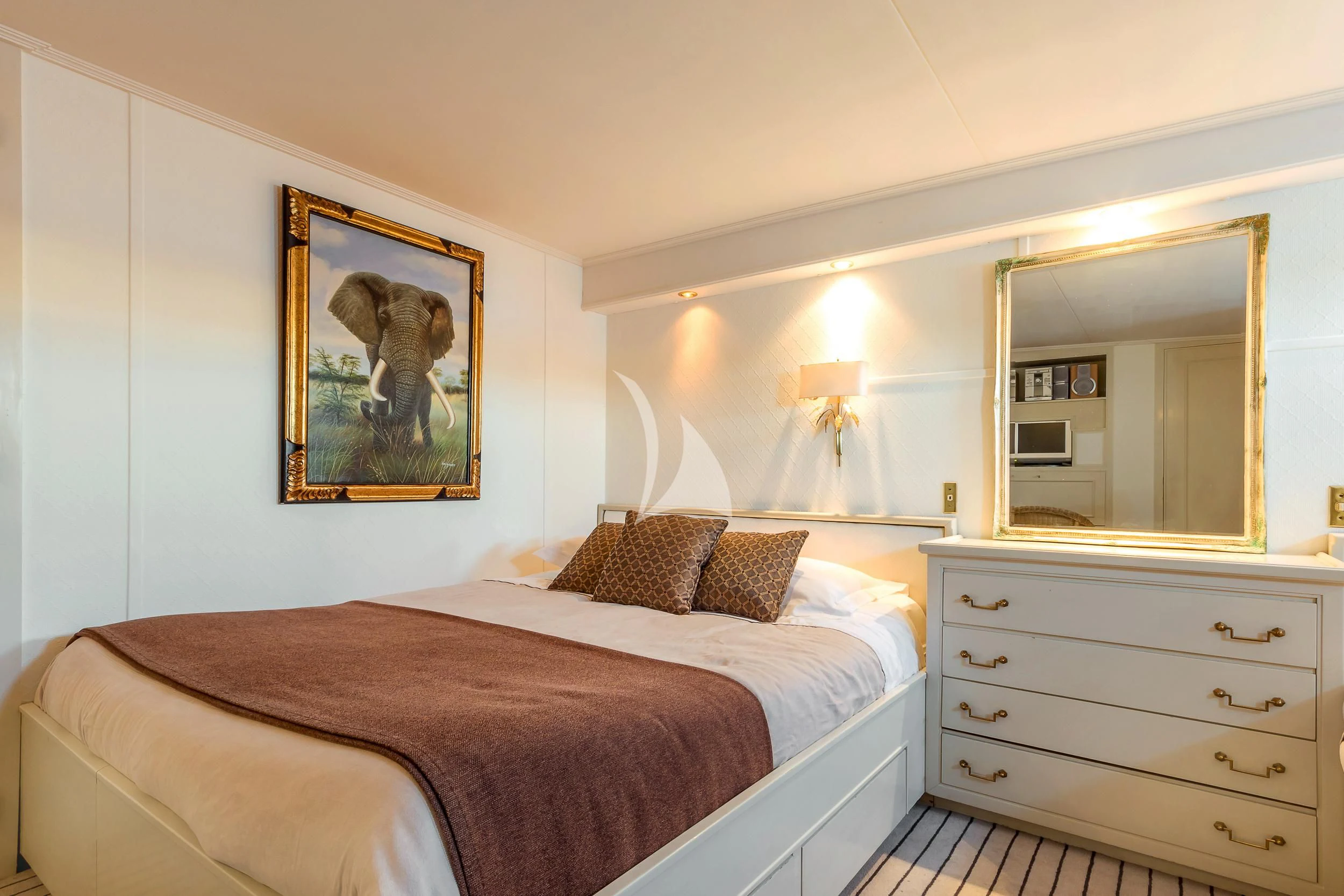 a bedroom with a bed and a painting on the wall aboard SECRET LIFE Yacht for Sale