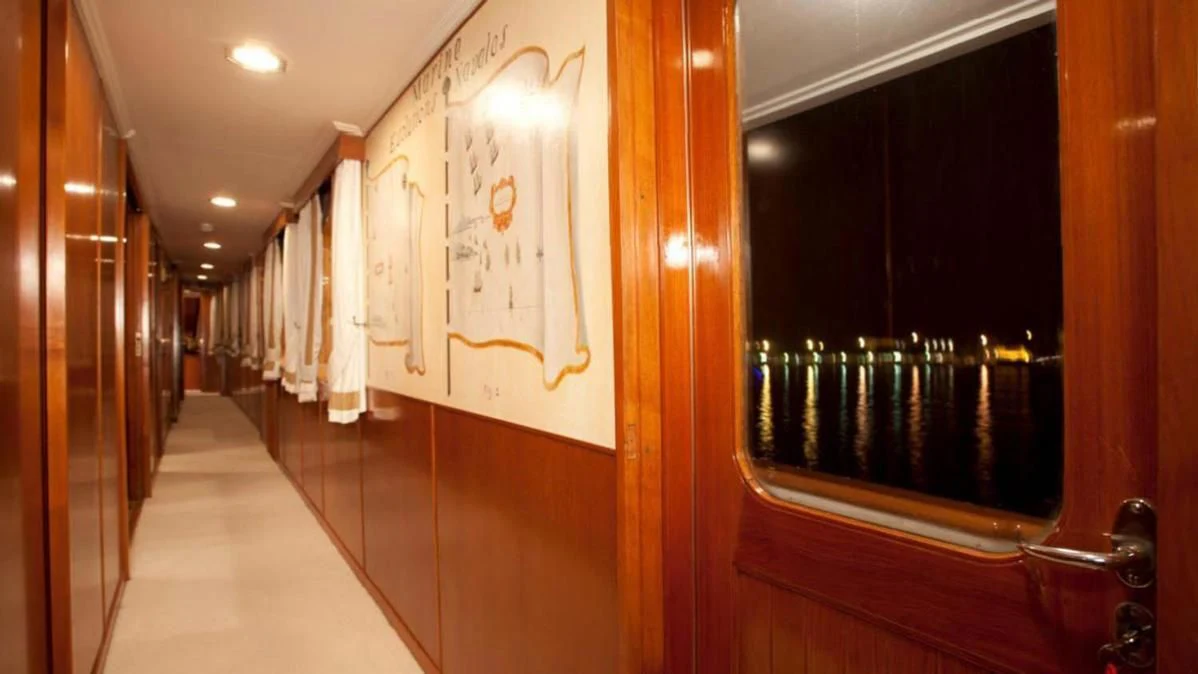 a hallway with a door and a window aboard SECRET LIFE Yacht for Sale