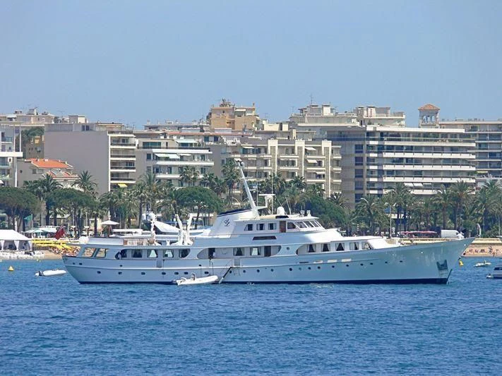 a couple of white boats in the water with a city in the background aboard SECRET LIFE Yacht for Sale