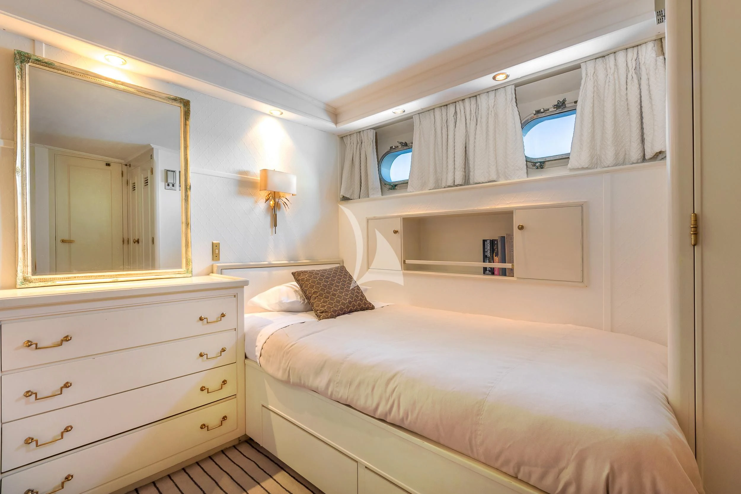 a bedroom with a bed and a mirror aboard SECRET LIFE Yacht for Sale