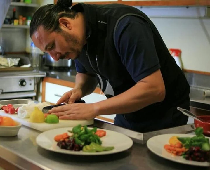a person preparing food in a kitchen aboard SECRET LIFE Yacht for Sale