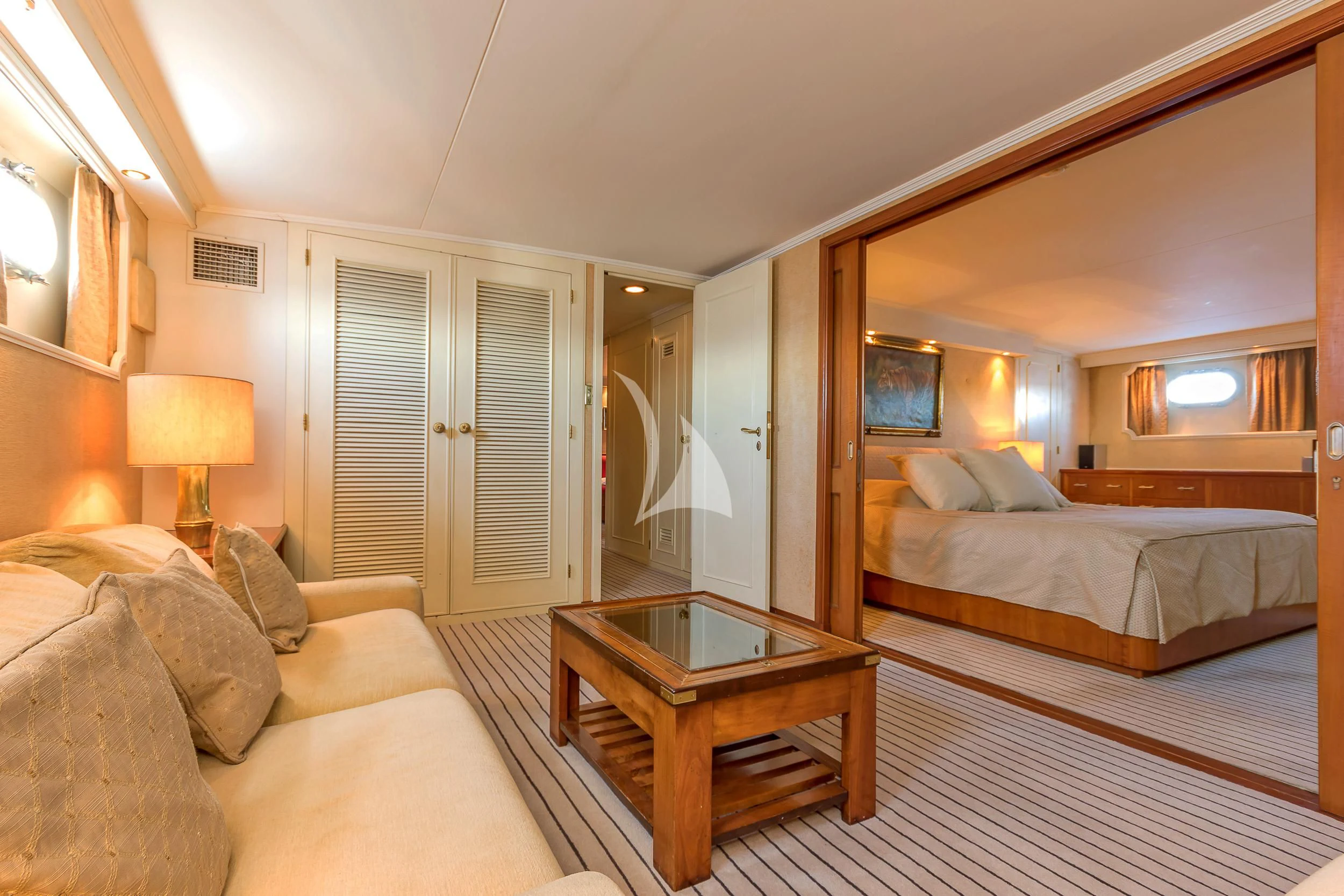 a hotel room with a bed and a coffee table aboard SECRET LIFE Yacht for Sale