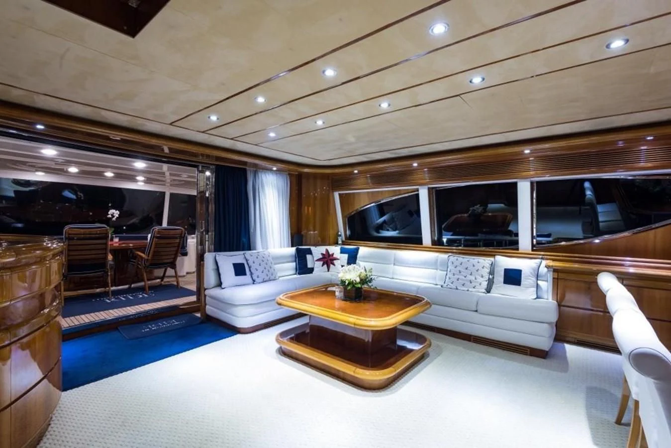 a living room with a large blue rug and a table aboard TOMORROW WE RIDE Yacht for Sale