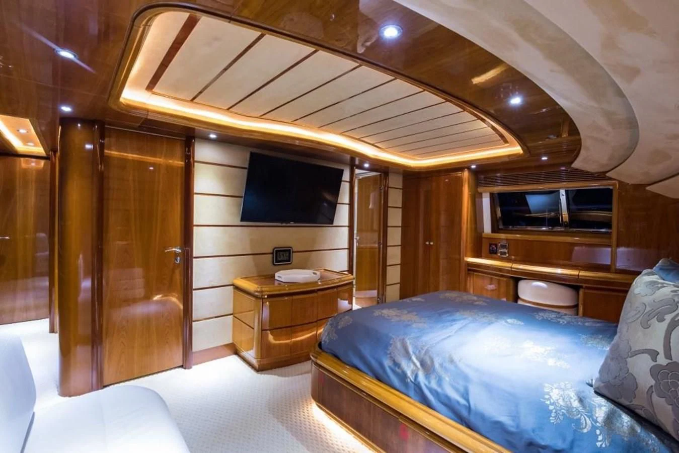 a bedroom with a bed and a tv aboard TOMORROW WE RIDE Yacht for Sale