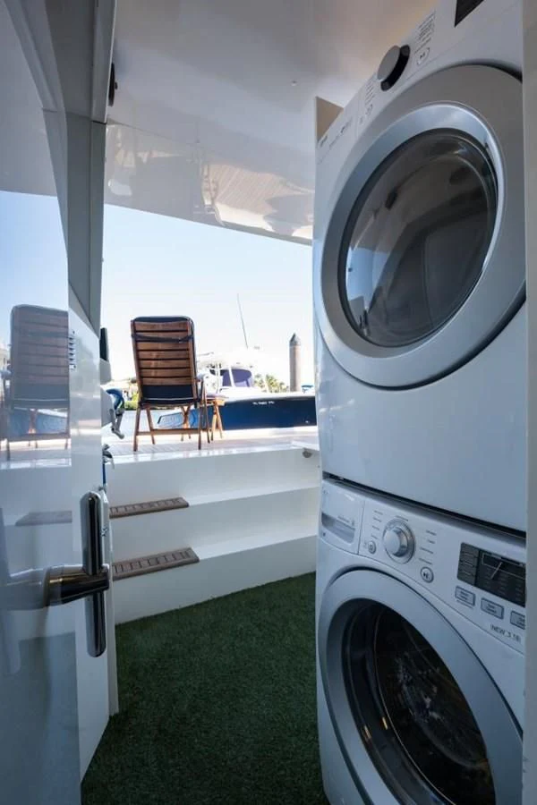 a room with a washing machine and a chair aboard TOMORROW WE RIDE Yacht for Sale