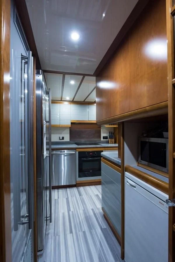 a kitchen with a large refrigerator aboard TOMORROW WE RIDE Yacht for Sale
