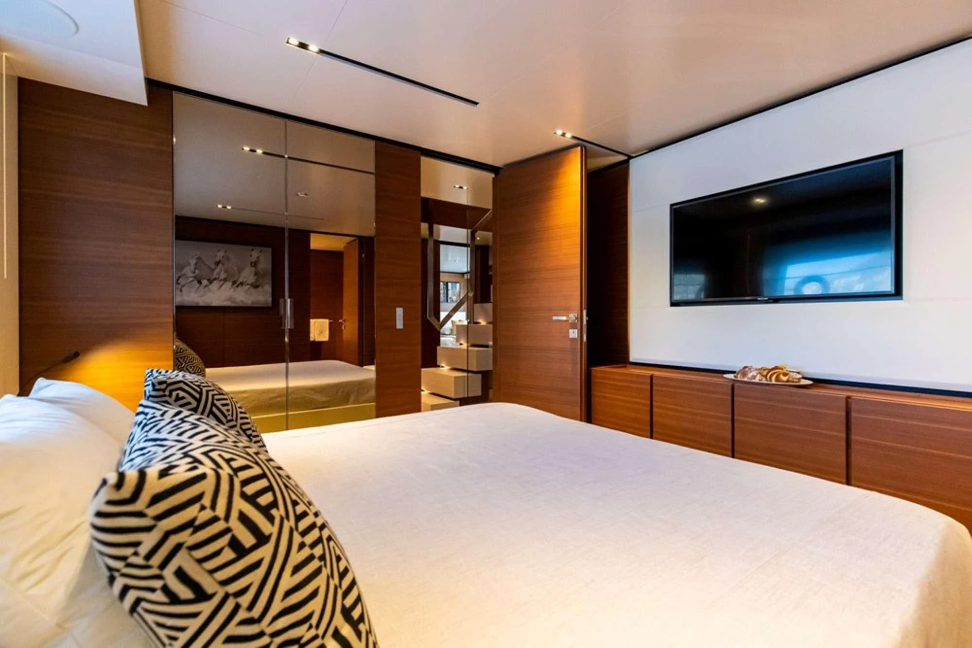 a hotel room with a bed and tv aboard SOUTH Yacht for Sale