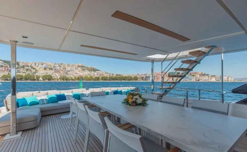 a balcony with a view of a city and water aboard SOUTH Yacht for Sale