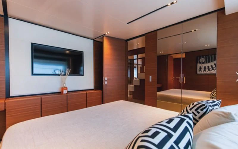 a bedroom with a bed and a tv on the wall aboard SOUTH Yacht for Sale