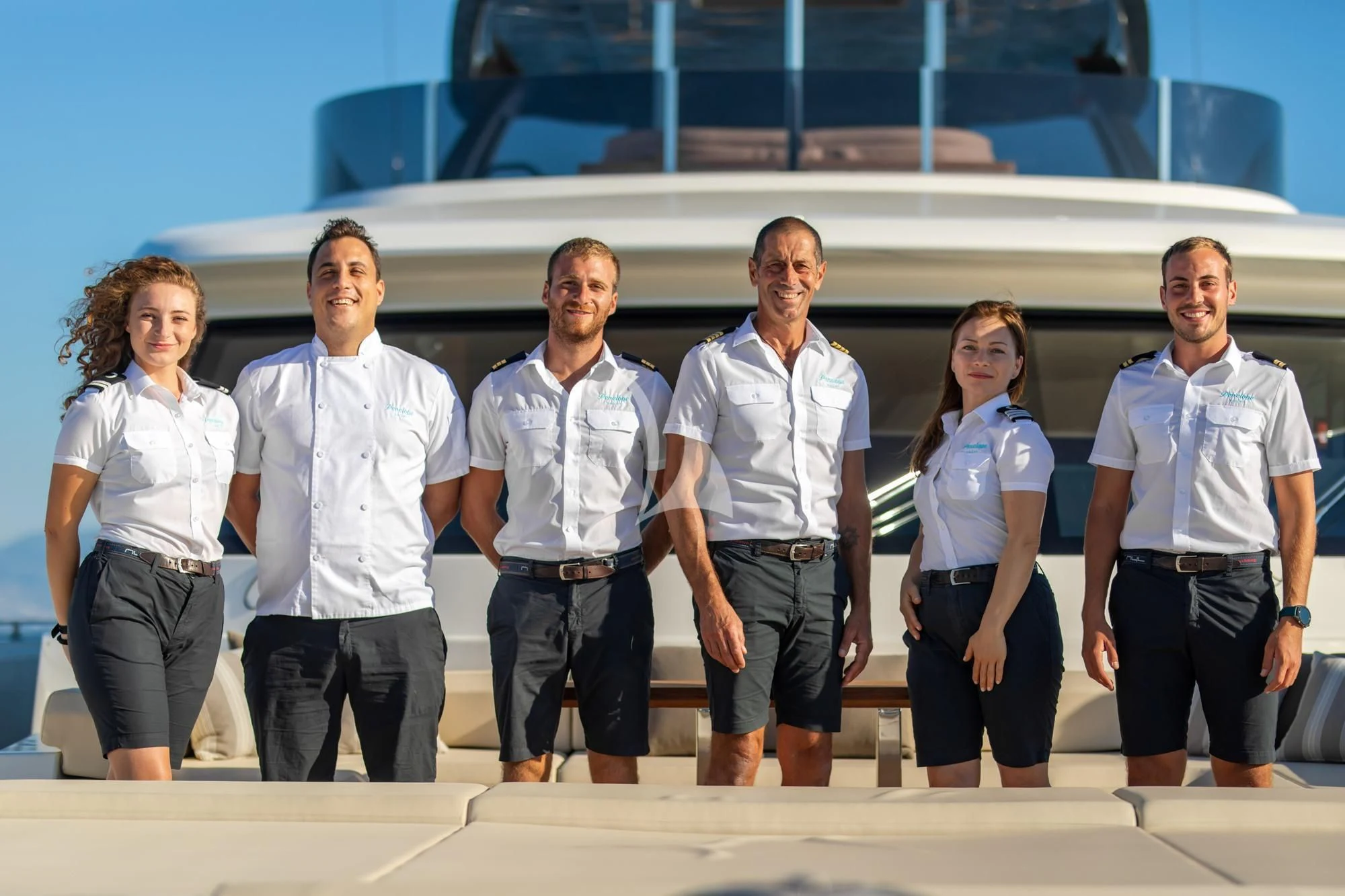 a group of people posing for a photo aboard SOUTH Yacht for Sale